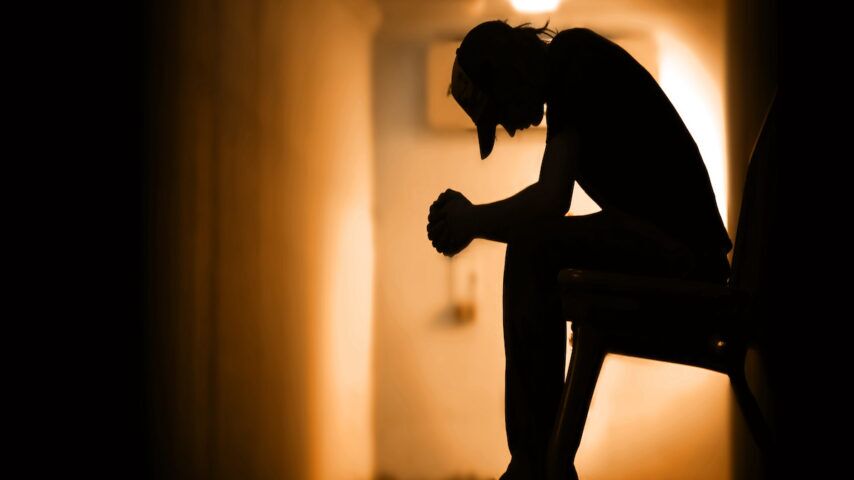 Young man with hands clasped together understanding dual diagnosis
