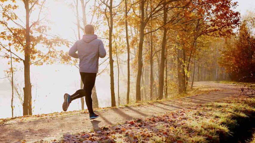 Man running or jogging in a park as part of his biophysical rehab